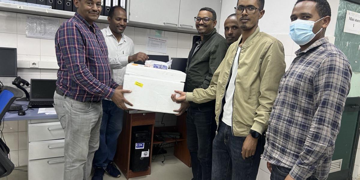 Six scientists in Ethiopia deliver reagents for use in laboratory testing to determine spread of disease.