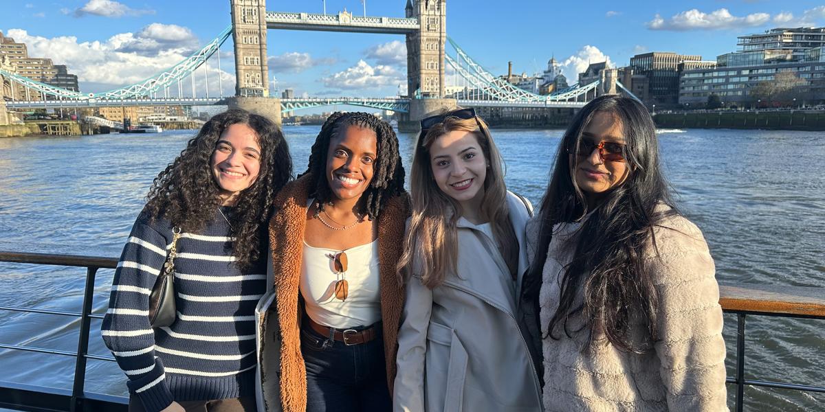 students posing with London Bridge in the background