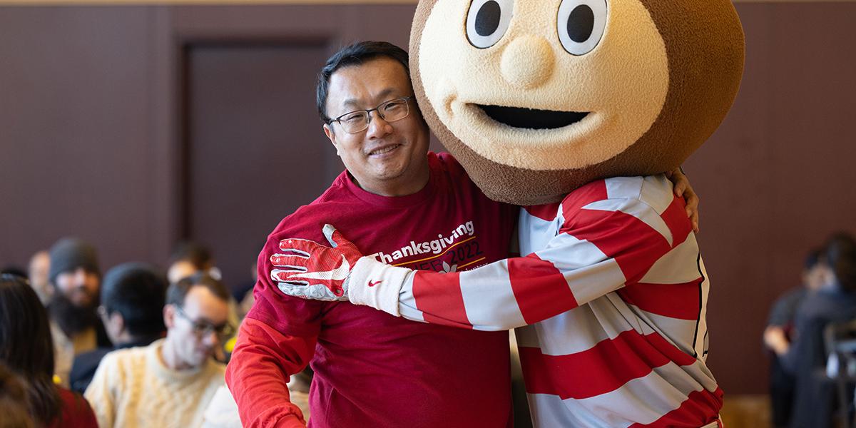 Thanksgiving dinner volunteer and Brutus are hugging