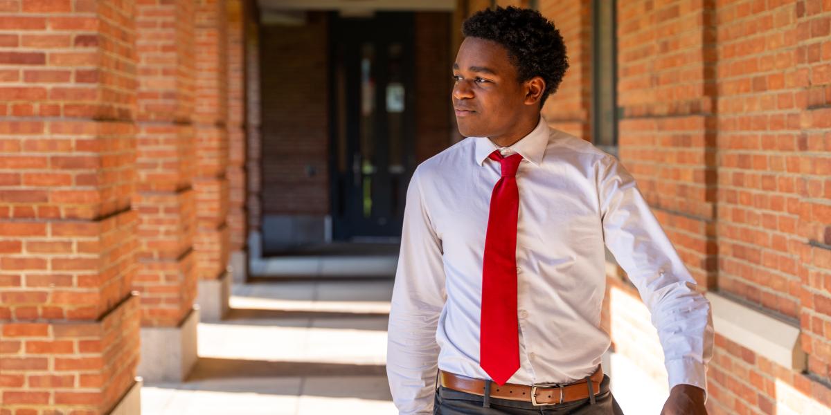 Student walking along Fisher Corridor