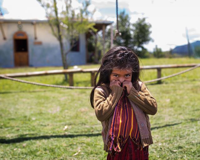 Little girl standing on grass field 