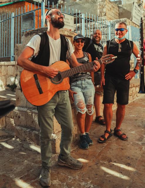 Musicians perform on a street.