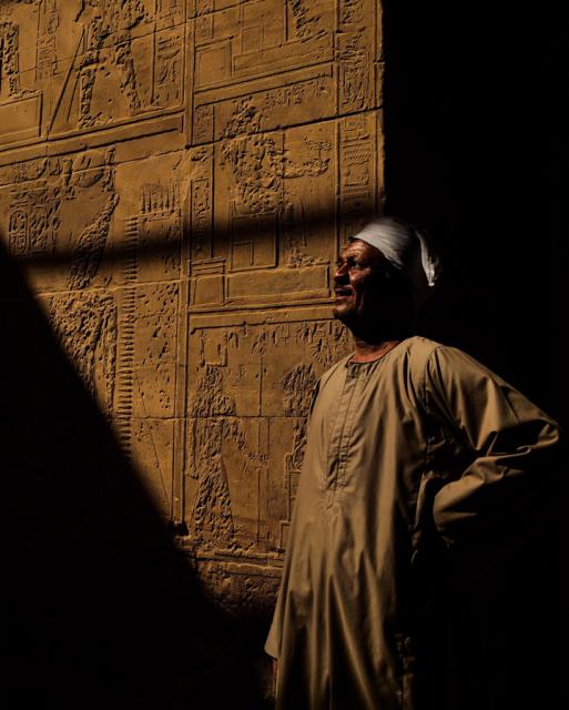 Man standing in front of temple wall