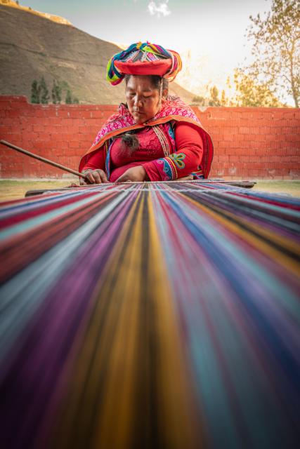 Quechua woman demonstrates a weaving tradition.