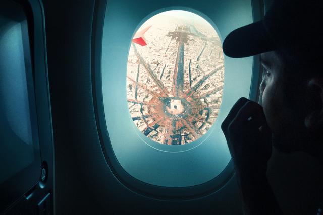 person looking out plane window