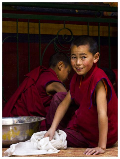 two little boys sitting on floor 