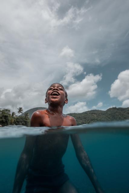 Boy in water smiling