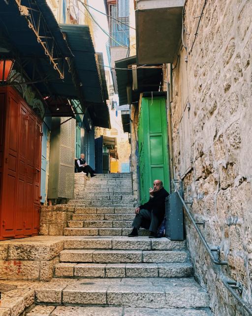 Two males sitting on steps