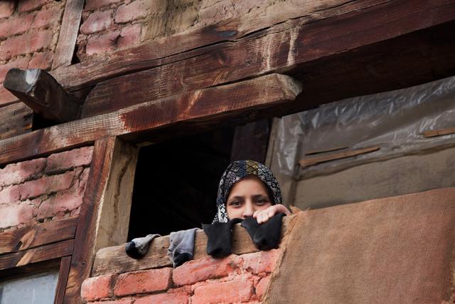 Woman looking over wall