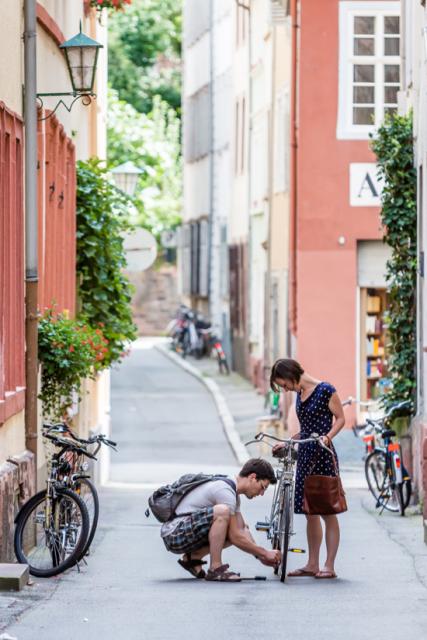 Man fixing womans bike in street