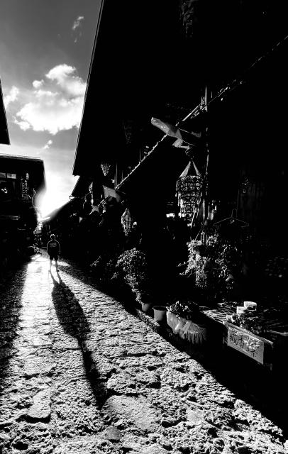 Long shadow of a person on a street.