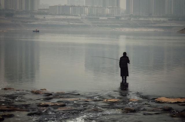Fisherman out on a pond.