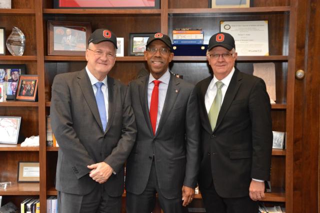 Three men wearing Ohio State baseball caps