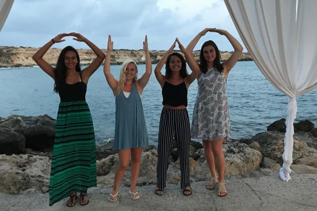 O-H-I-O spelled out by four women.