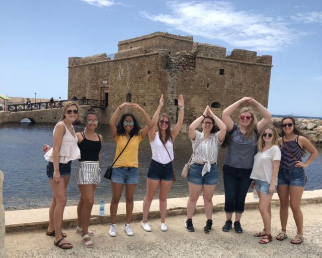 Students spell O-H-I-O with castle in background.