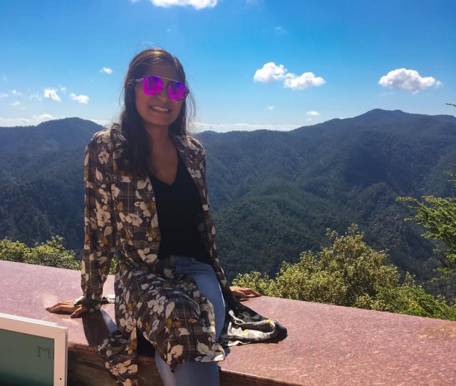 Female with mountains in background.
