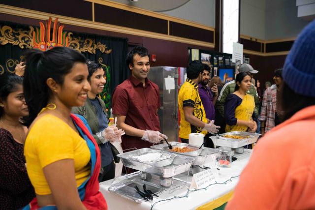 A student serving food at Taste of OSU.