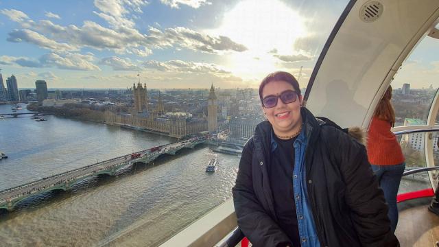 Woman in ferris wheel above London.