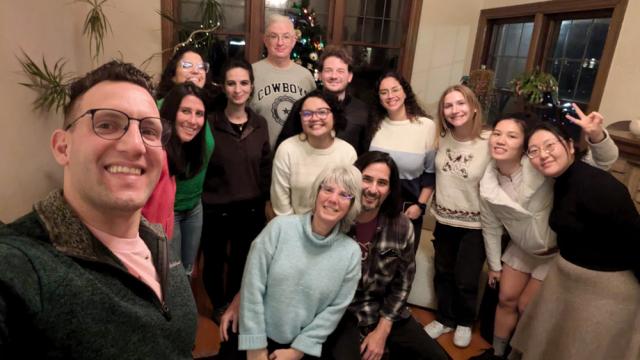 Group of people pose for photo indoors