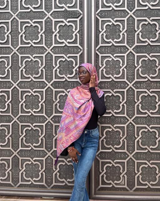 Woman stands by middle eastern door