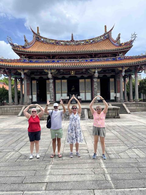 A group doing O-H-I-O while in Taiwan.