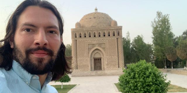 Selfie of male in front of temple.
