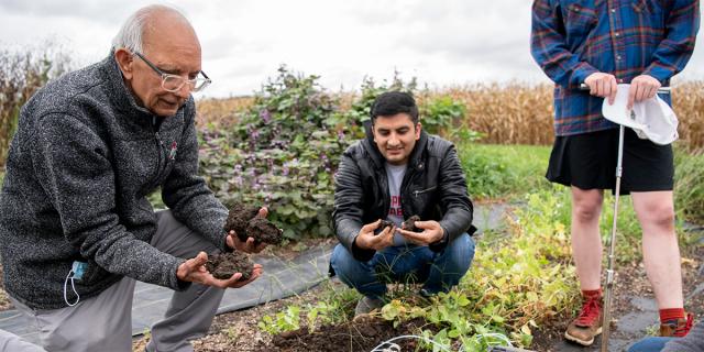 Rattan Lal shows students a soil sample