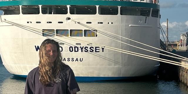 Student next to ship