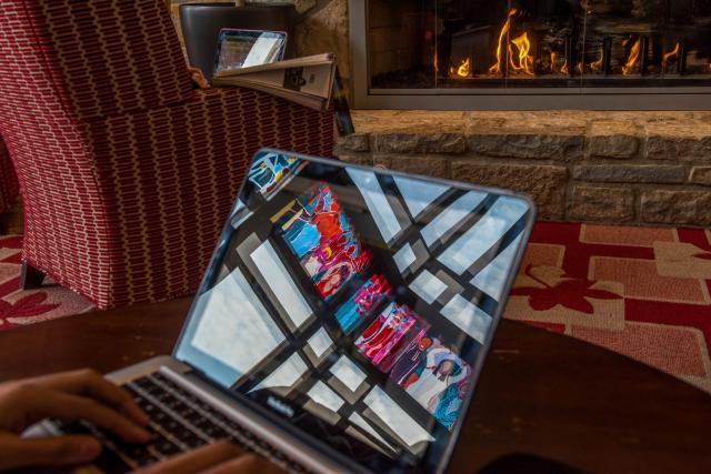 student studying with laptop in front of fireplace in Ohio Union.