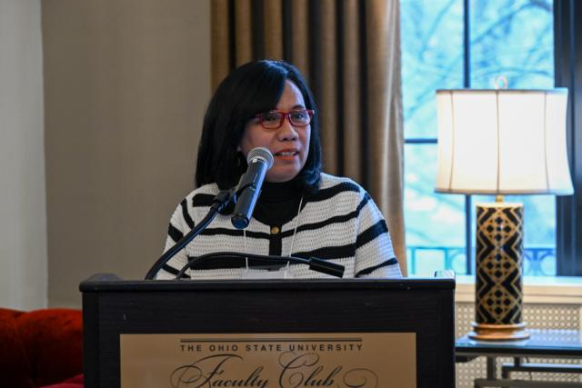 Woman at podium speaking.