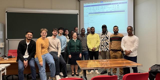 Group of students with a faculty member in a classroom
