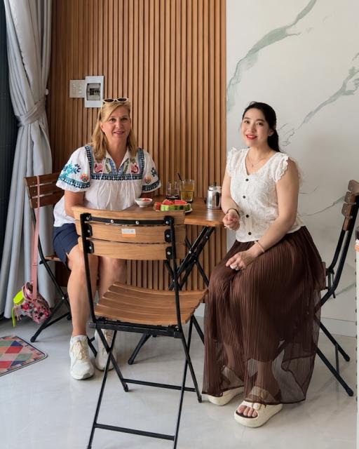 Two women sitting at small table.