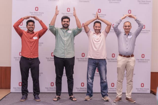 Four men spell out O-H-I-O with their arms