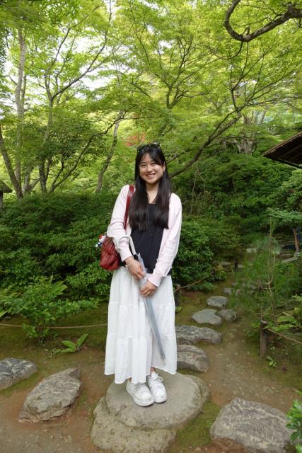Woman smiling in a forest setting.