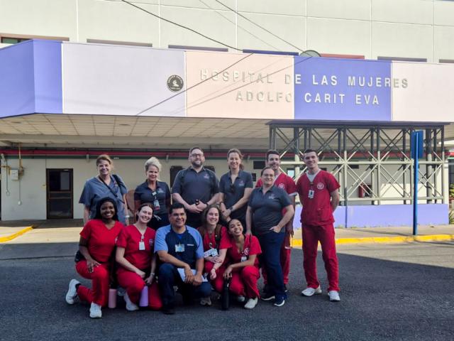 Nurses posing in from of hospital