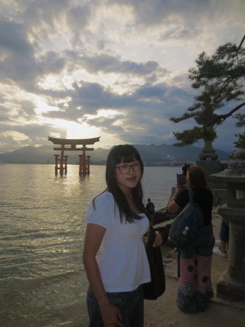 Student near temple shrine in water