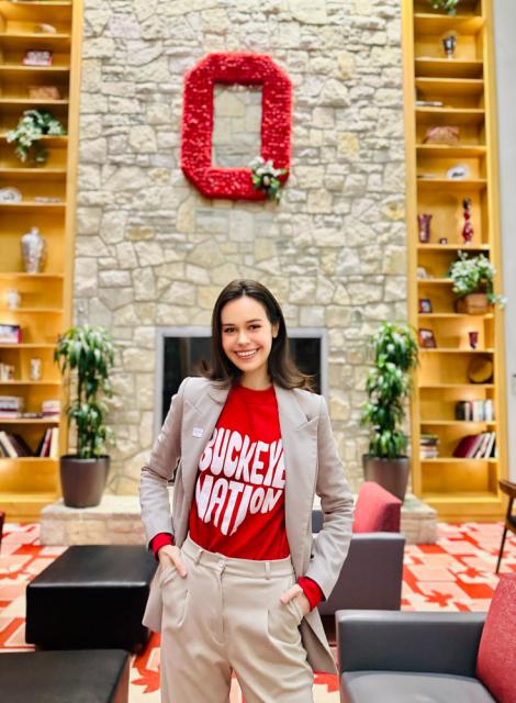 Woman wearing a blazer and Ohio State Buckeye Nation t-shirt with Block O on wall