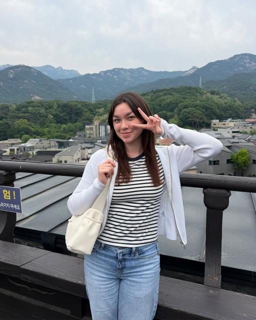 Student posing near mountain range