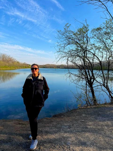 Woman wearing sunglasses poses by Antrim Lake in Columbus.