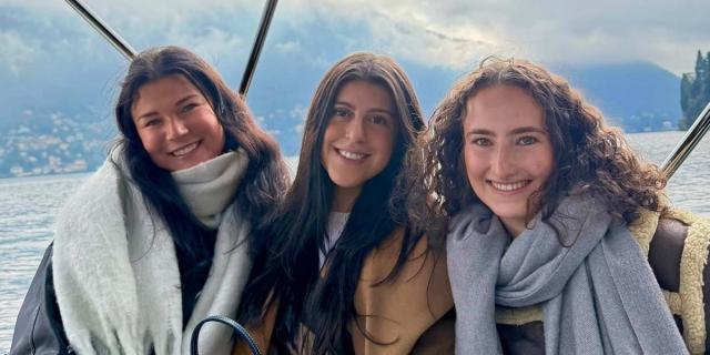 Students smiling on a boat