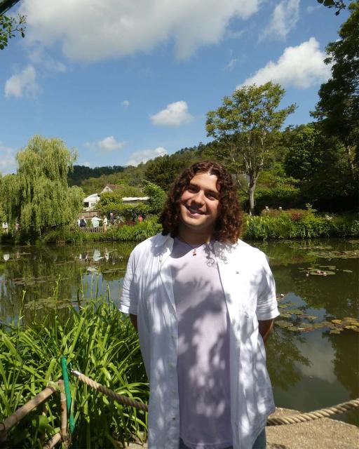 Student overlooking pond and garden