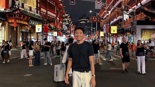 Student in busy street in China