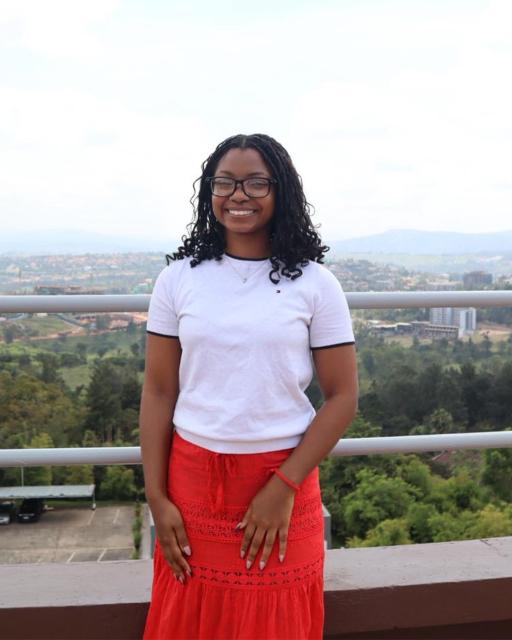 Student posing overlooking city skyline