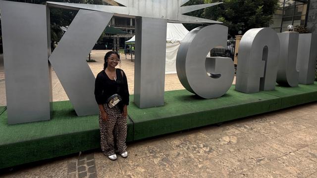 Student in front of medal sign
