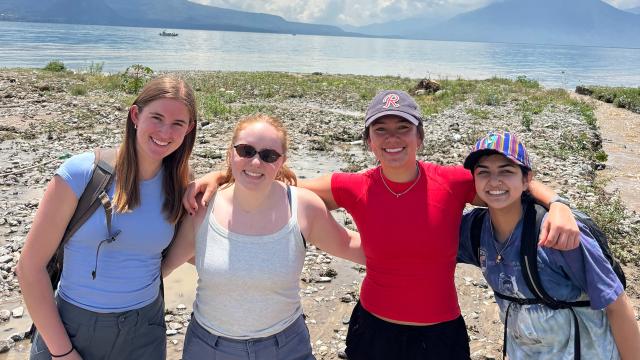 Students posing near a lake