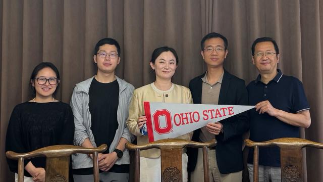 People holding an Ohio State pennant