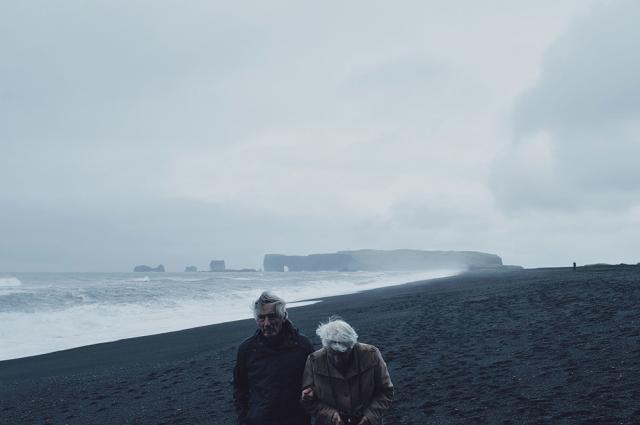 Elderly couple walking on beach