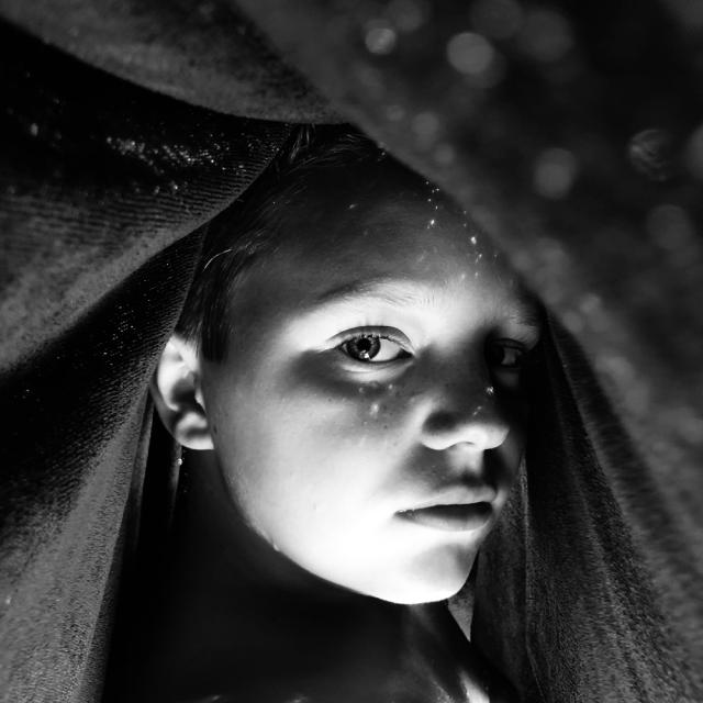 Closeup of girl under a blanket.