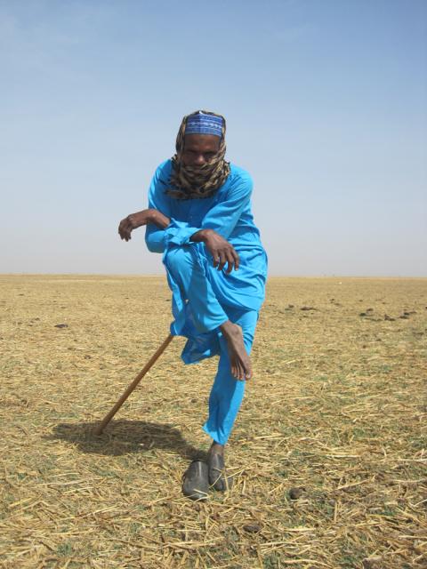 Man in colorful outfit standing in field