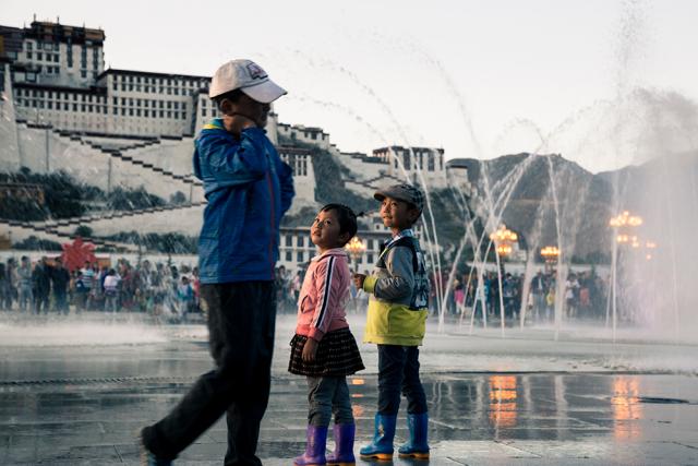 people standing by fountain